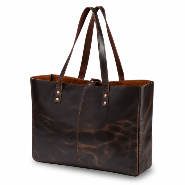 A professional studio shot of a dark brown, distressed leather tote bag isolated on a solid white background. The bag showcases prominent natural patina ripples across its surface, a center vertical stitched seam, dual reinforced shoulder straps secured with brass rivets, and a tan interior lining.