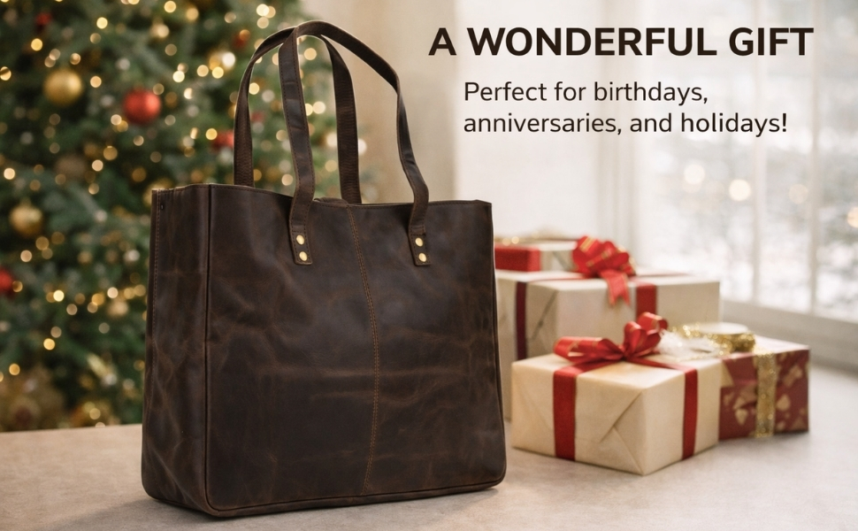 A holiday-themed product marketing infographic featuring a structured dark brown leather tote bag on a tabletop. In the background, a softly blurred Christmas tree with glowing lights stands to the left, and a stack of gift-wrapped boxes with red ribbons sits to the right by a bright window. Text in the upper right corner reads "A WONDERFUL GIFT. Perfect for birthdays, anniversaries, and holidays!"